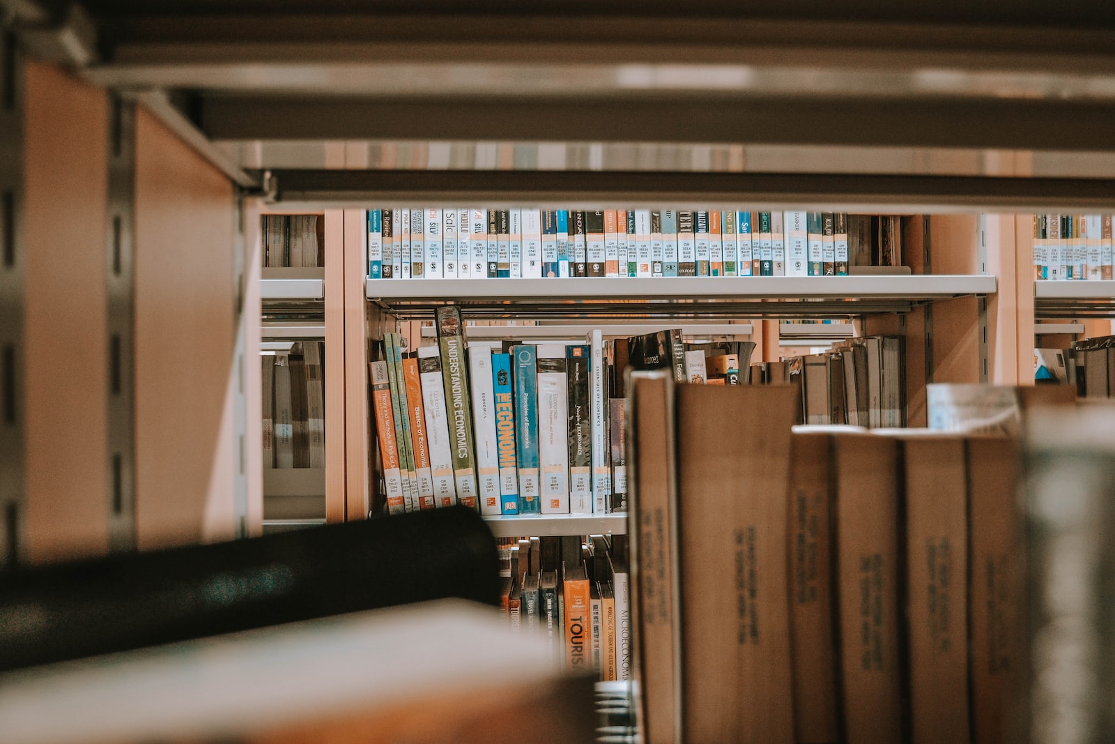 books on brown wooden shelf