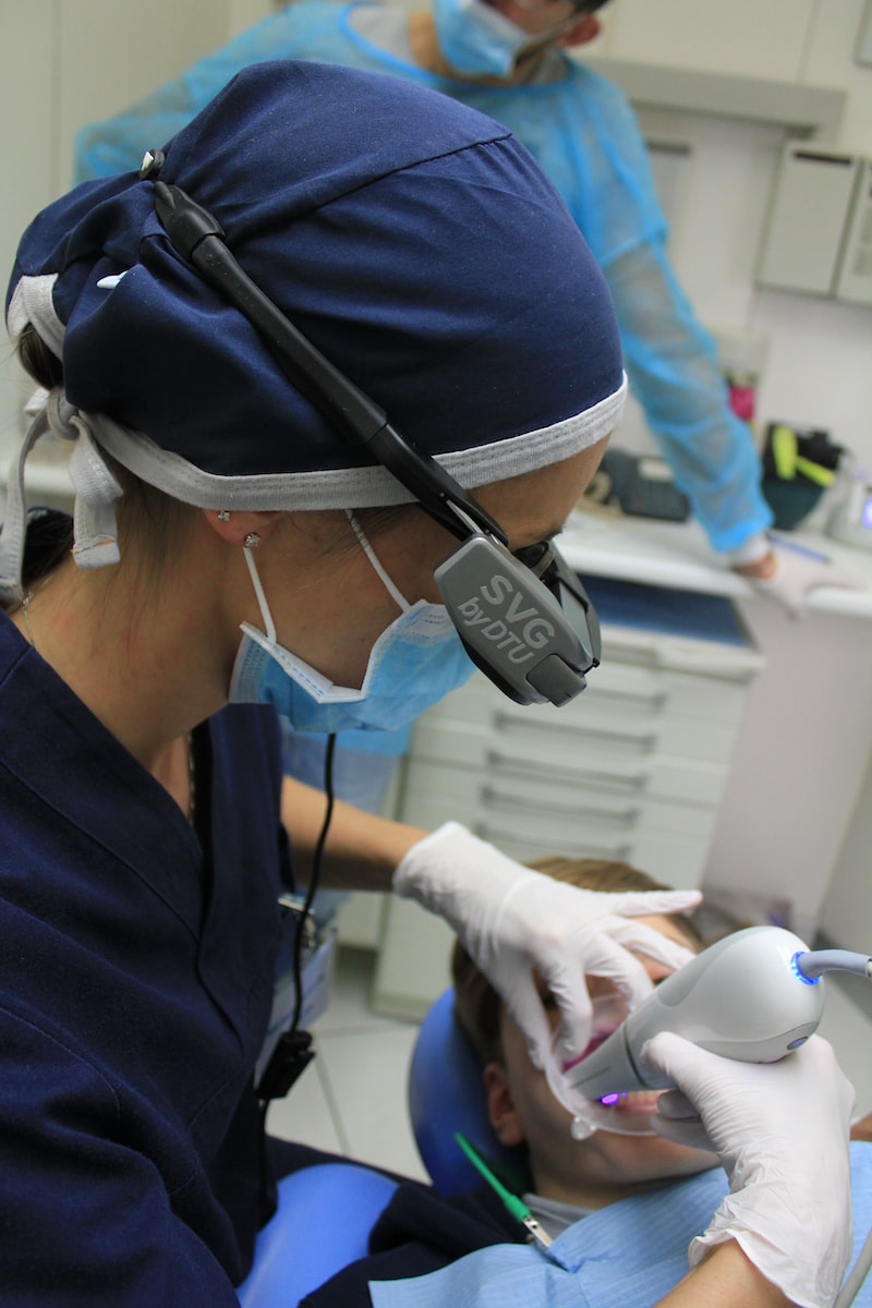 woman holding white medical tool